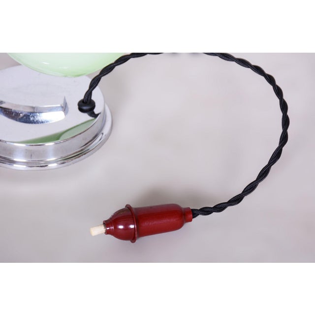 This table lamp is an iconic representative of Functionalist design and the Bauhaus movement in 1930s Czechoslovakia. Its...