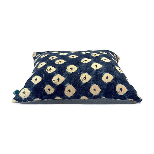 Handcrafted from authentic African mudcloth, this pillow blends bold geometric patterns with earthy tones and subtle pops...
