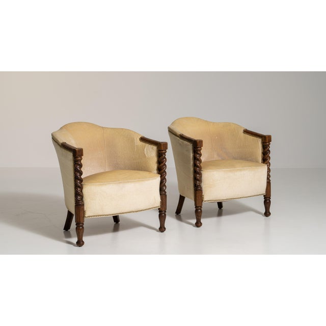 A brown wood, Jacobean-style armchair, dating to the early 20th century and made in UK. The wood frame is finished in...