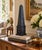 A beautifully proportioned black and grey faux-marbled patterned obelisk with brass mounts. The sculptural silhouette and...