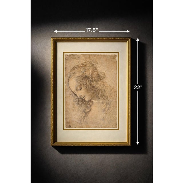 A beautifully framed reproduction of Leonardo da Vinci’s Head of a Woman (La Scapigliata), presented with a softly aged,...