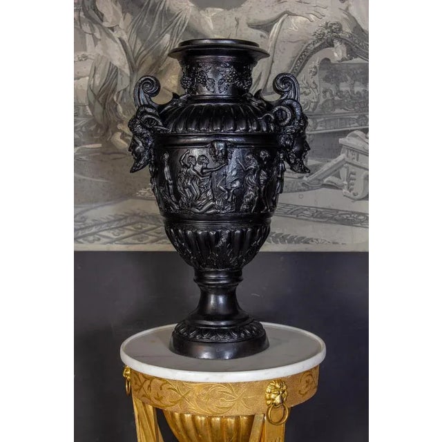 Impressive pair of black patinated bronze vases in the style of Renaissance. Finely decorated handles with a satyr figure,...