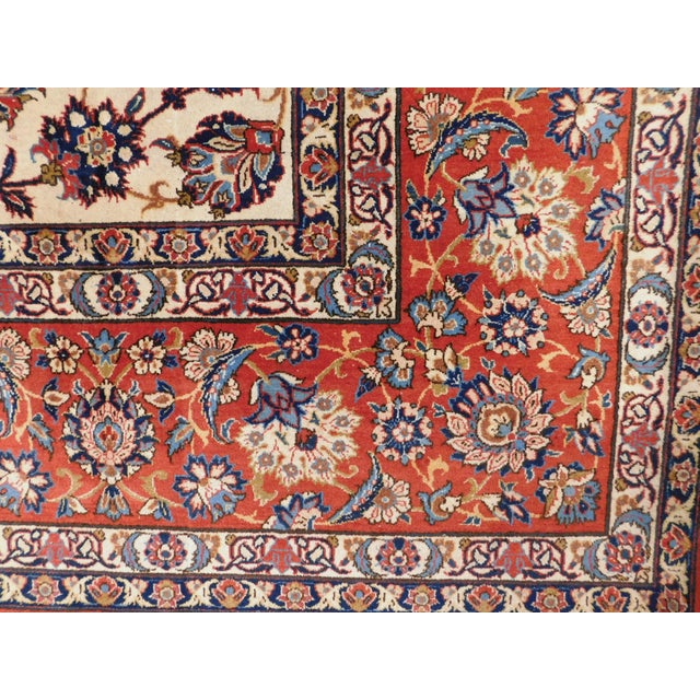 Mid-century hand knotted room size Persian rug. Cream field with allover floral pattern, within red border, decorated with...