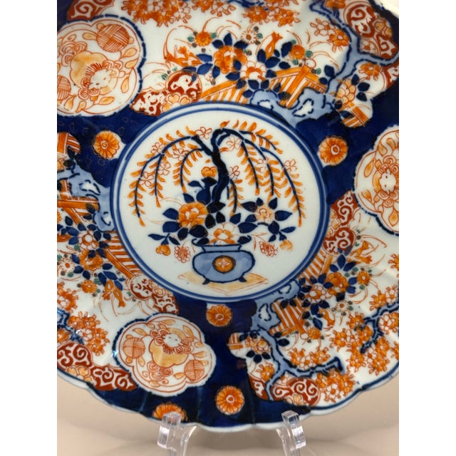 Late 19th Century / Early 20th Century antique Imari plate with scalloped edge. Featuring vibrant oranges, blues, and...