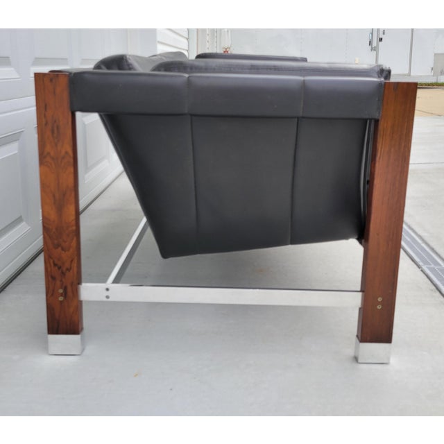 Sophistication says it all. Made of Rosewood, vinyl naugahyde, and aluminum metal, this vintage mid century compact sling...