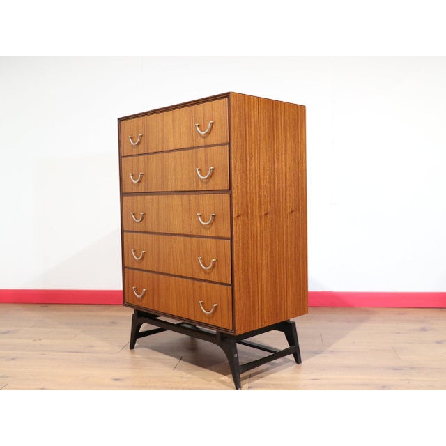A gorgeous dresser in the style of Meredew, this Mid Century Modern Vintage Teak Dresser Chest embodies timeless Danish...