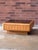 A distinctive vintage California Modern coffee table, circa late 1970s to early 1980s, featuring a warm golden oak frame...