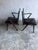 Striking pair of mid-century armchairs dating from the 1950s–1960s. The chairs feature sculptural dark-stained wooden...