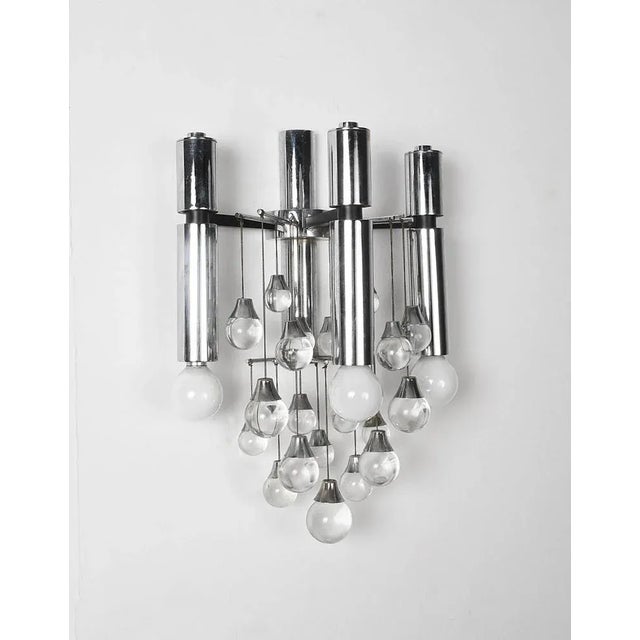 Amazing pair of chrome and glass sconces with three lights. This wonderful piece was produced in Italy during the 1960s....