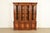 A gorgeous French Regency or Neoclassical style lighted breakfront bookcase or dining cabinet In the manner of Baker...