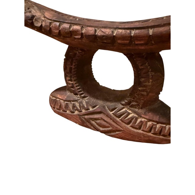 Large carved wooden headrest from the Pacific Islands. With traditional motifs and a modern form.