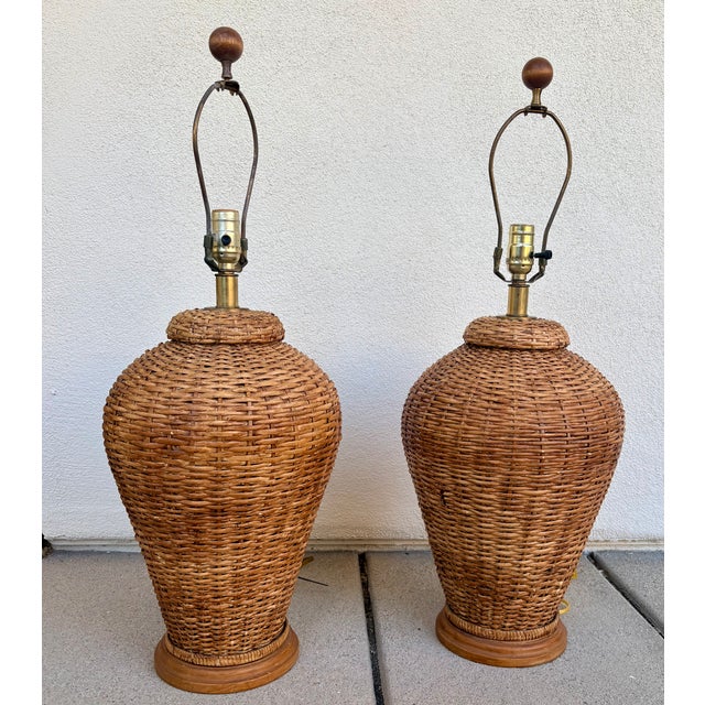 In the style of Ralph Lauren Home, this fabulous pair of woven rattan wicker ginger jar shaped table lamps with round...