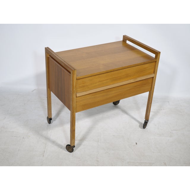 Mid-century sewing box on wheels from the 1960s. Compact, functional design with clean lines and a warm wood tone in the...