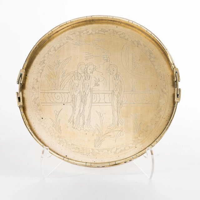 China trade cast brass standing rim brass tray engraved with three female figures in a domestic garden. The tray is fitted...