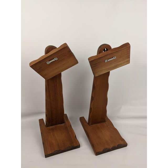 An unusual matching pair of vintage Mid-Century primitive wooden wall shelf sconces featuring distinctive sculptural...