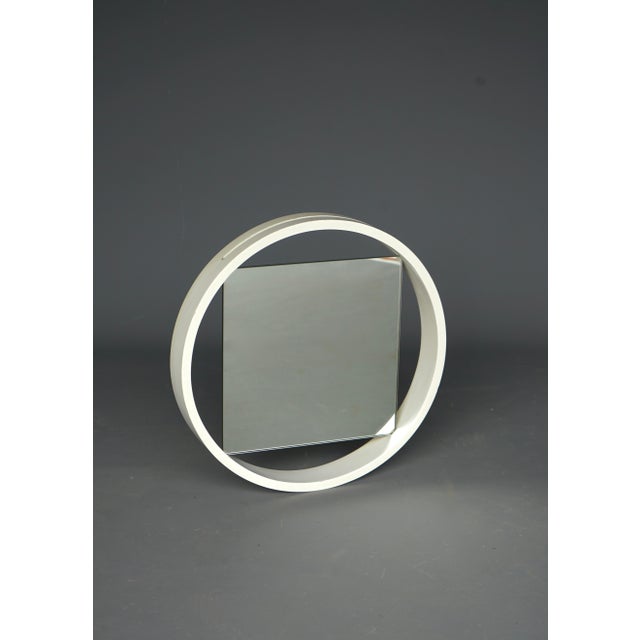 A simple constructivist mirror with a circular wooden surround into which a square mirror slips and sits inside I have...