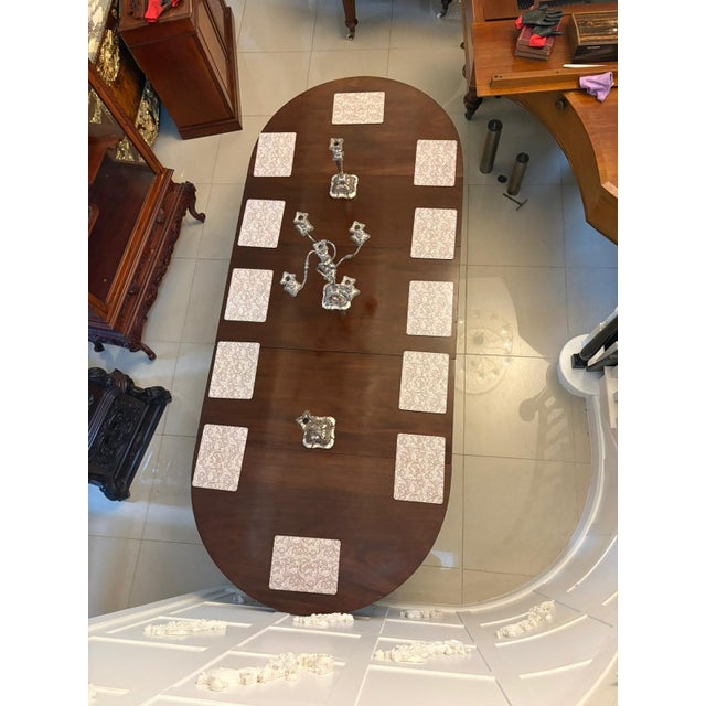 A fine quality Georgian mahogany triple pillar dining table of generous proportions designed to seat twelve to fourteen...