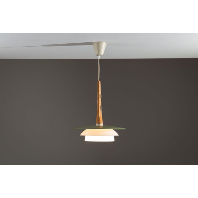 This vintage pendant light is a beautiful example of mid-century craftsmanship, combining natural materials with refined...