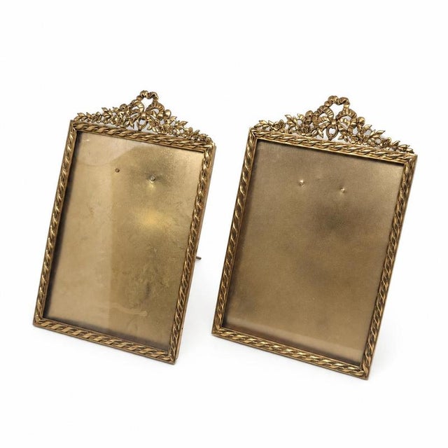 Rectangular frames with ribbon crowning, flowers and branches, glass front and easel feet. Cataloguing: period c....