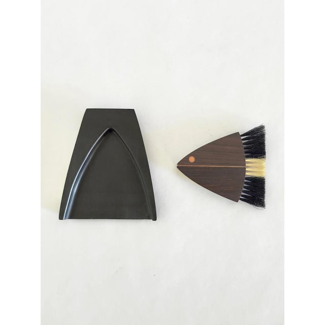 Crumb brush and tray set by Laurids Lønborg, produced in Denmark in the 1960s–70s. The brush is carved in a stylized fish...