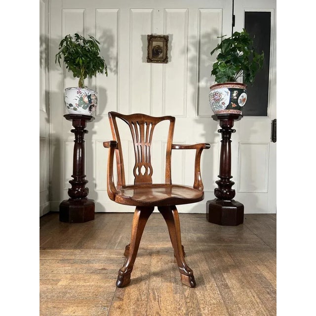 Superb quality, walnut desk chair by the acclaimed furniture makers Howard & Sons. A rare model with pierced splat and...