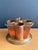 Patinated copper and brass four bottle wine cooler with ice compartment.