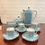 Beautifully colored in robin's-egg blue with white stripes bordered by thin black lines. Noritake demitasse service for 4...