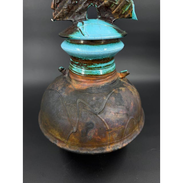 Signed studio pottery lidded vessel by American ceramic artist George Whitten. The piece features a raku-fired surface...