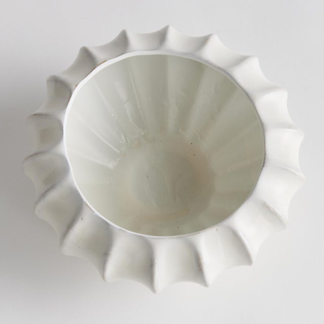 With a sculpted body and thickly applied glaze, this coastalinspired low bowl is a work of art. The handfinished details...