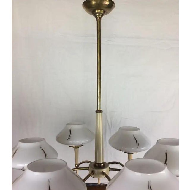 Maison Arlus style chandelier produced in France, circa 1950s. The peculiarity that distinguishes this chandelier is its...
