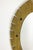 Elliptical mirror in hammered and gilded brass, with a cut edge decorated with 8 grey iron cabochons. A work of art by a...
