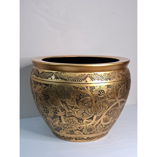 A striking vintage ceramic cachepot in the traditional Chinese fishbowl form, featuring an elegant black and gold finish...