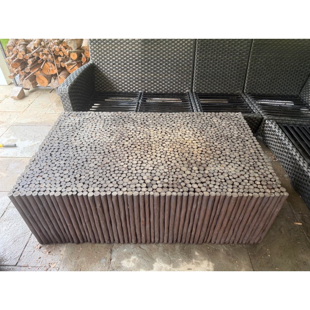 A showstopping coffee table built entirely from solid peeled logs in a Kahlua finish, topped with a dense end-grain “log...