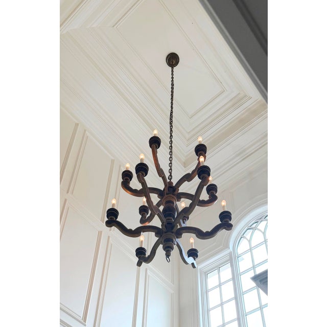 Paul Ferrante Style. Large Two-Tier French Provincial 12 Light Wooden Chandelier with a turned baluster center column and...