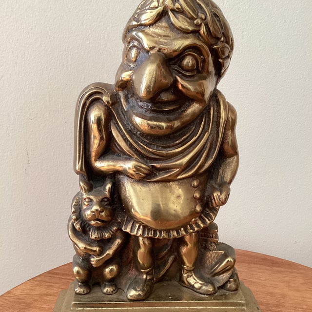 A wonderful bronze doorstop or door porter in the form of Mr. Punch dressed as a Roman emperor. A cartoon of Punch in...