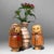 Adorable vintage pair of wooden kokeshi dolls with charming, hand-carved details. The figures feature expressive faces and...