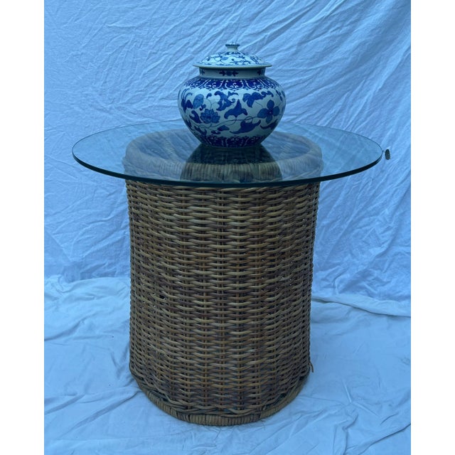 A modern take on classic wicker rattan, this vintage round accent table is slightly taller than an average side table...