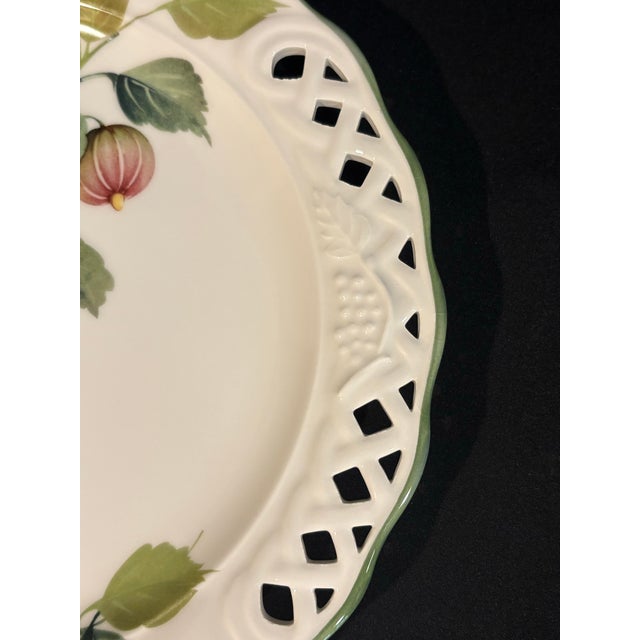 This round platter from Brunelli features a blooming fig branches motif, a delicate pierced lattice design, embossing and...
