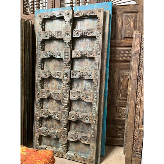 Bring timeless character and artisan craftsmanship into your home with this antique hand-carved teak wood barn door....
