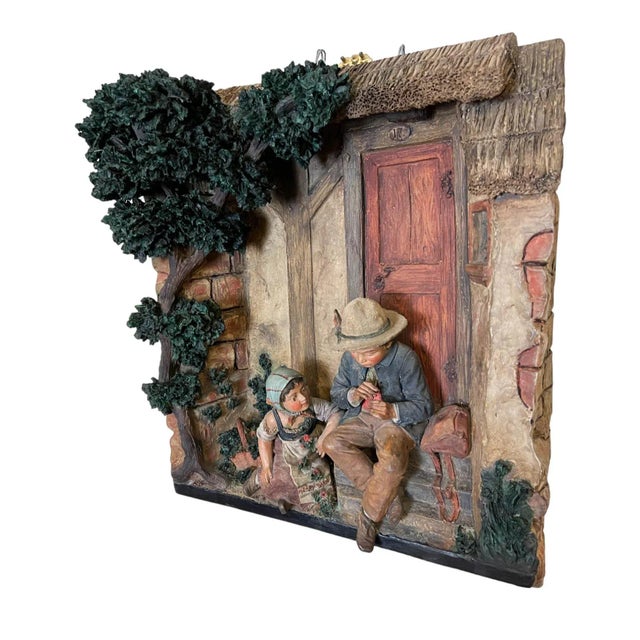 The relief embodies elements of Romanticism and folk art, with intricate, lifelike details of clothing, trees, and the...