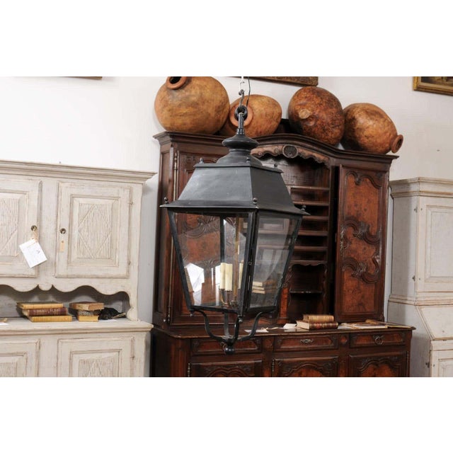 Emanating the graceful elegance of early 20th-century French design, this iron lantern from circa 1900 seamlessly blends...
