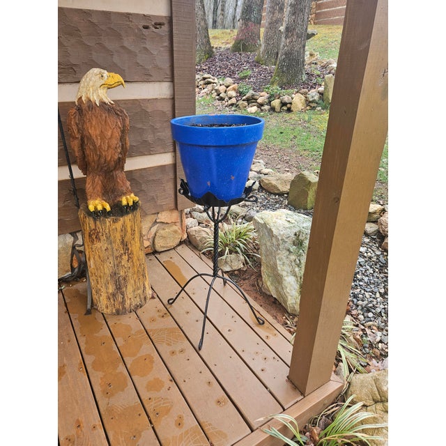 This wrought iron plant stand features a hand-forged twisted stem and a sturdy four-leg base. It has been professionally...