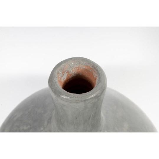 This beautiful 12.5-inch redware pottery vase features a graceful, classic silhouette finished in a rich earthy gray glaze...
