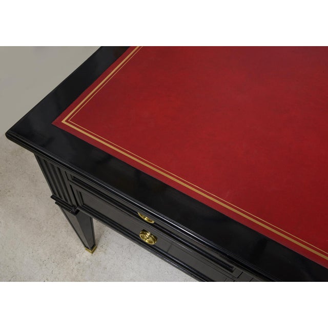 Vintage Ebonized French Bureau Plat Faux-Partner Desk with Tooled Red Leather Top and Tapered Legs on Brass Sabots.