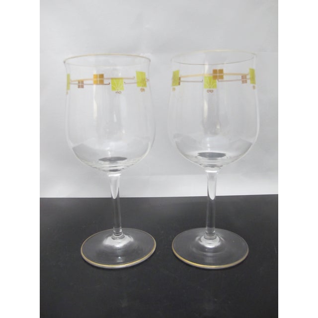 Very fine pair of crystal wine glasses. Mid century modern gilt and green enamel design. Thin stems, very light and...