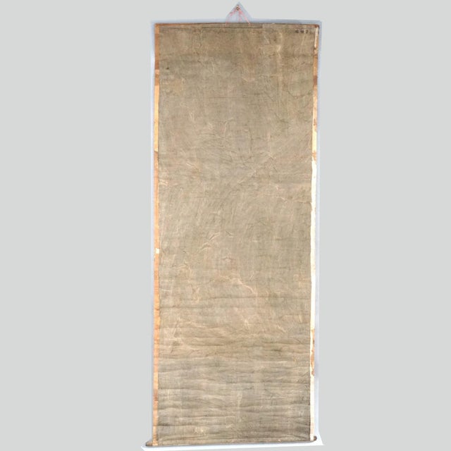 An oversized antique Chinese scroll painting offers depiction of deity with figures, 19th century Measures - 69" x 26.5"