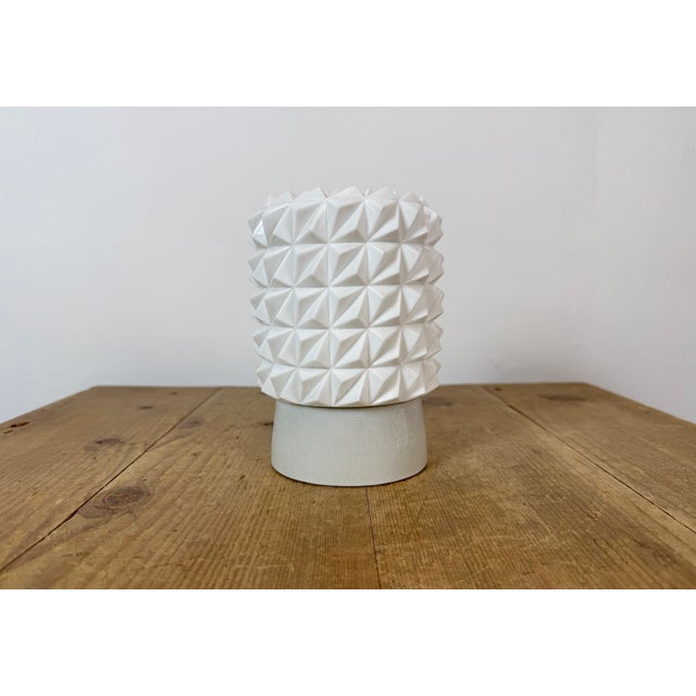 Vintage industrial ceiling or wall light made in former Czechoslivakia during the 1970s. It features a white porcelain...