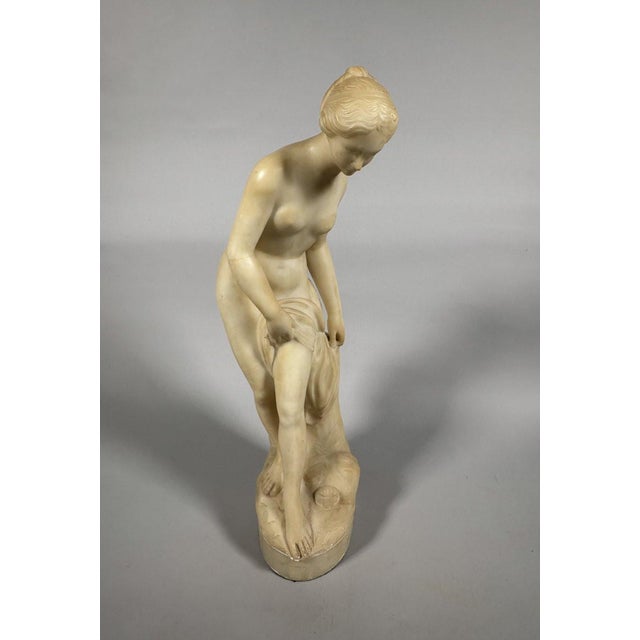 A Siena yellow marble sculpture depicting Diana at her bath, after a model by Falconet, 1757. Fine quality white marble....