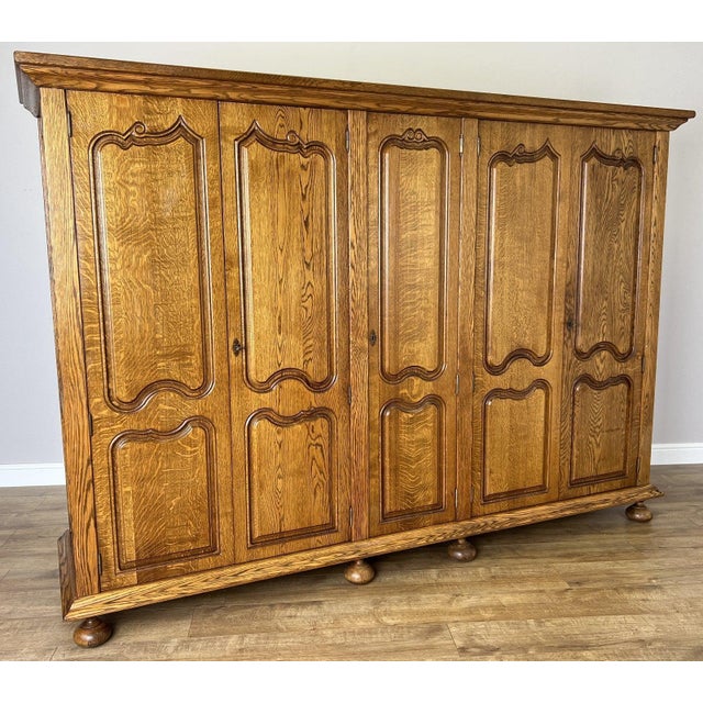 A striking Vintage French wardrobe crafted from oak, featuring an impressive five door design with beautifully shaped...
