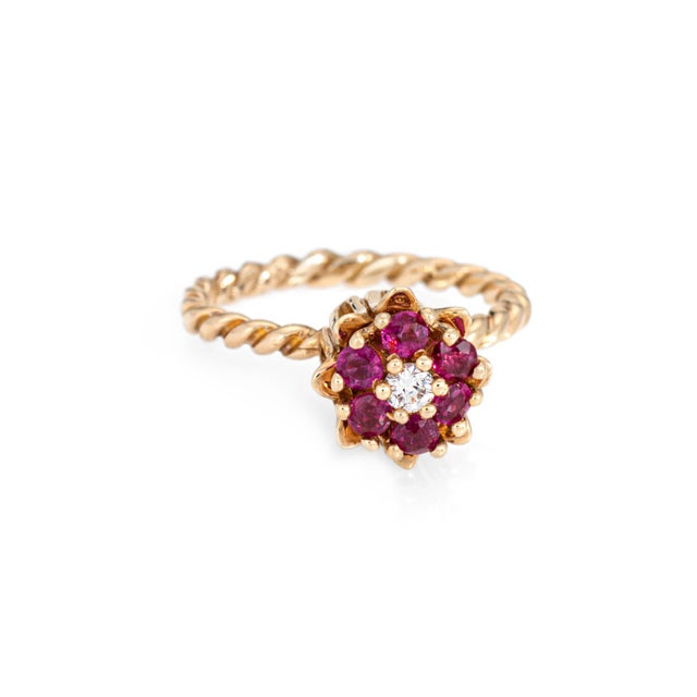 Stylish vintage ruby & diamond tulip ring (circa 1960s to 1970s) crafted in 10 karat yellow gold. Round brilliant cut...